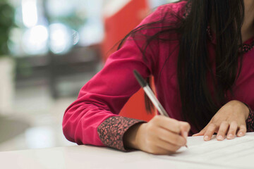 Crop shot of a business person with pen signing document