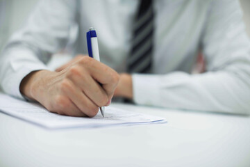 Crop shot of a business person with pen signing document
