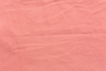 Background texture of orange pink woven fabric for wear made of soft cotton. Spring and summer...