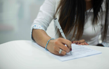 Crop shot of a business person with pen signing document