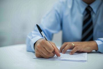 Fototapeta premium Crop shot of a business person with pen signing document
