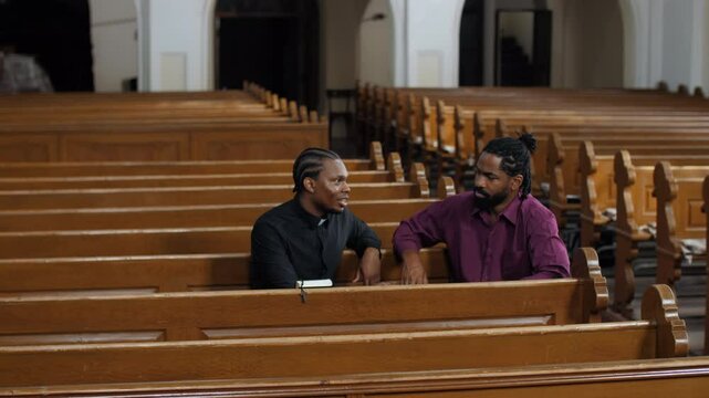 Priest listening to parishioner problems in church, slow motion