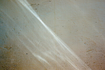 The reflection of the water cast by the morning sun on part of a white weathered wall of a farm house, in the eastern Andean mountains of central Colombia.