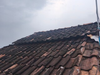 Rooftiles that have been eaten away by age. pattern rooftile,rows of rooftiles lined up