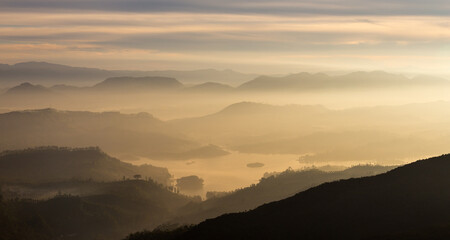 View from Adam's peak, Sri Lanka. Valley view with lakes and mountains at sunrise.