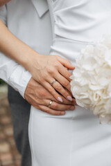 A man holds a woman's hands with wedding rings. Support for loved ones. Couple outdoor love