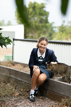 schoolgirl in uniform with her pet cat