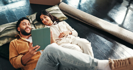 Couple, relax and floor on tablet in new home for relocation, interior design and online shopping. Above, people and discussion with digital app, furniture search and decision for renovation planning