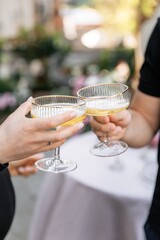 Couple drinking cocktails cheering with a glass