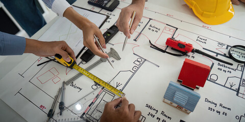 Architecture and Collaboration. Construction team analyzing design blueprints and planning...