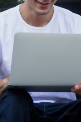 Young casual entrepreneur working on laptop at home office.