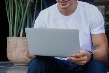 Young casual entrepreneur working on laptop at home office.