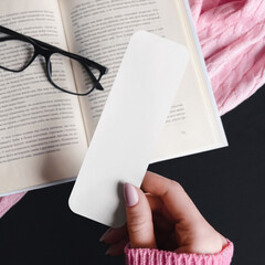 Woman puts a bookmark in a book mockup