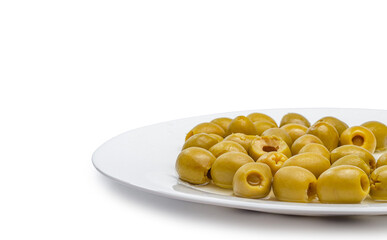 Green olives on white plate close-up