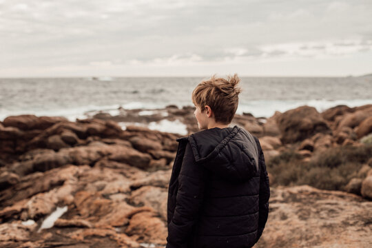 back shot of a boy on a windy day