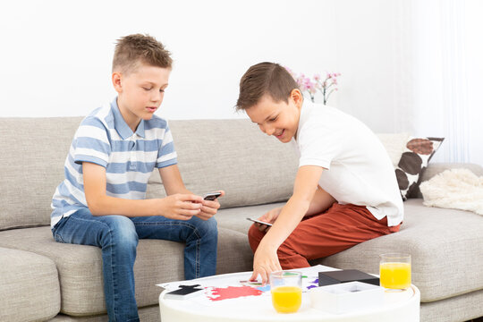 Two kids playing card game spending quality leisure time at home.