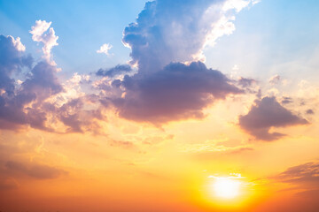 Obraz premium Sky,sunset, beautiful , luxury soft gradient orange gold clouds and sunlight on the blue sky perfect for the background, Sunrise on morning or evening in winter warm time ,Twilight summer,silhouette