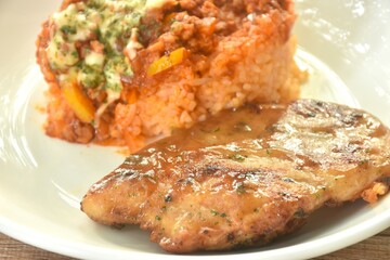 Mexican fried rice with grilled Chicken dressing spicy chop tomato and onion sauce on plate