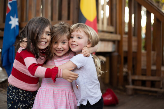 Early education, three girls hugging