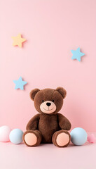 Brown teddy bear sits amidst pastel balloons and stars on pink background