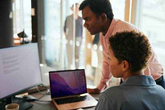 Aff&auml;rsman- och kvinna arbetar tillsammans p&aring; dator