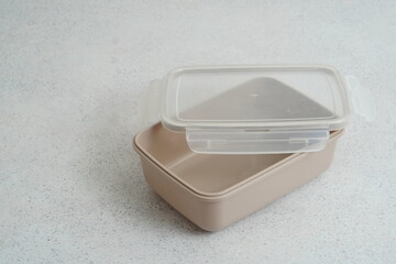 Beige plastic food container on light background