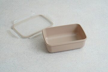 Beige plastic food container on light background