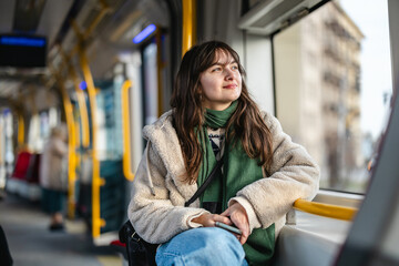 Young woman looking out of the tram window
