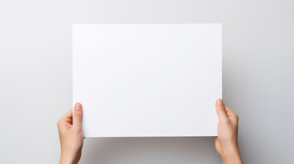 Hand holding blank paper on white background