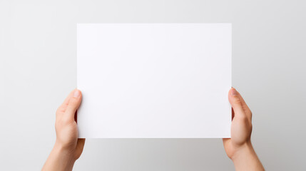 Hand holding blank paper on white background