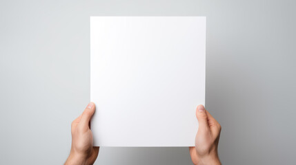 Obraz premium Hand holding blank paper on white background