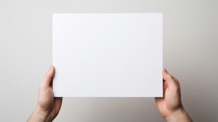 Obraz premium Hand holding blank paper on white background