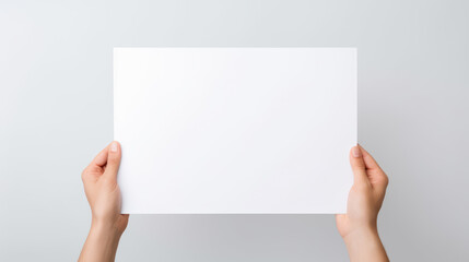 Hand holding blank paper on white background