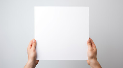 Hand holding blank paper on white background