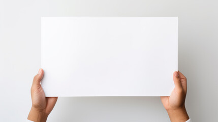 Hand holding blank paper on white background