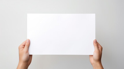 Obraz premium Hand holding blank paper on white background