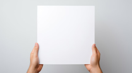Obraz premium Hand holding blank paper on white background