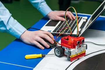 A student programs his robot using a netbook