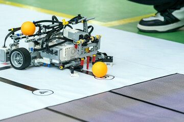 The robot uses a mechanism to grab the ball