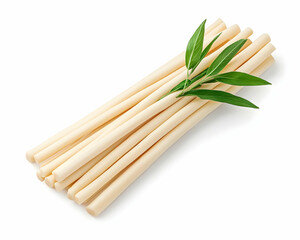 Creamy, pale yellow sticks arranged neatly, garnished with green leaves, isolated on white