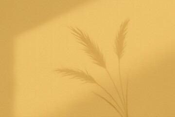 A soft shadow of grass plants on a warm yellow wall, creating a serene atmosphere.