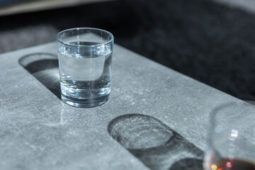 Close up pouring purified fresh drink water from the bottle on table in living room