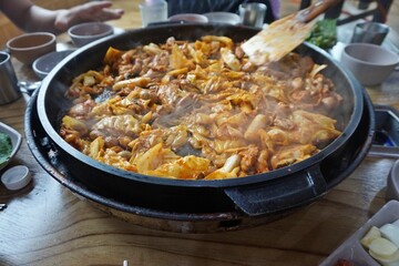 Spicy Dak Galbi Stir-Fried at the Table in a Korean Restaurant