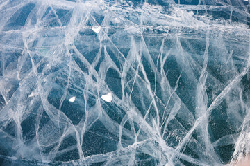 A detailed closeup of a unique piece of ice that remarkably resembles a delicate spider web, showcasing its intricate beauty and design