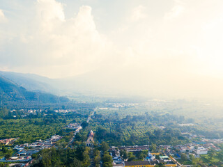 Aerial view of the city of Antigua Guatemala covered in the sunset mist.