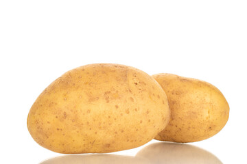 Unpeeled raw potatoes with kitchen utensils isolated on white background, close-up.