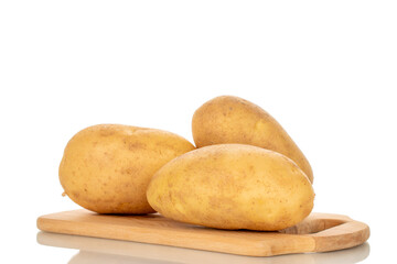 Unpeeled raw potatoes with kitchen utensils isolated on white background, close-up.