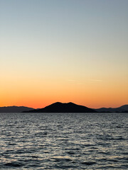 sunset twilight after the sea has set over the mountain above the sea