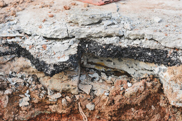 Close-up view of cracks in road under construction.