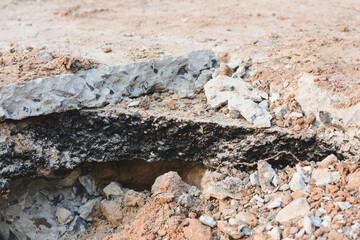 Close-up view of cracks in road under construction.